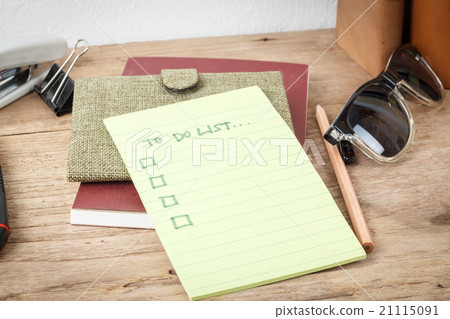 A small notebook with a to do list and a pen A small notebook with a to do list and a pen 21115091