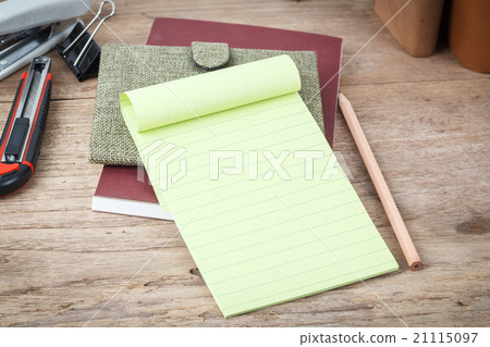 Green lined note paper on wood table Green lined note paper on wood table 21115097