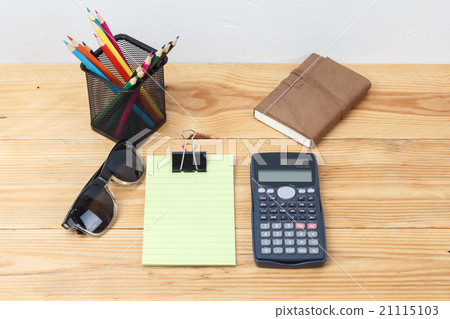 Green lined note paper with calculator on wood table for backgro Green lined note paper with calculator on wood table for backgro 21115103