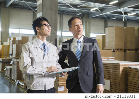 Two men in work wear clothes and suit in business image warehouse 21119331
