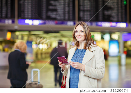 woman at international airport waiting for flight woman at international airport waiting for flight 21120674