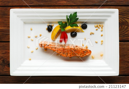 Restaurant food - grilled salmon with lemon. 21123147