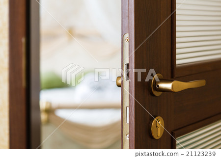Half open door of a hotel bedroom 21123239