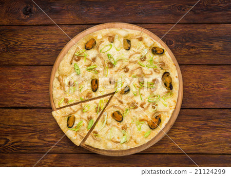 Italian seafood pizza top view at wood background 21124299