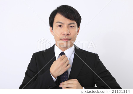 A businessman who fixes a necktie A businessman who fixes a necktie 21131314