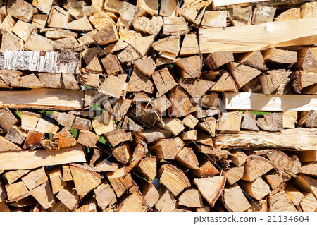 Background of dry chopped firewood logs in a pile 21134604