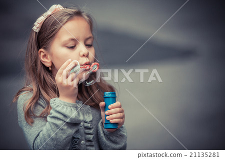 funny lovely little girl blowing soap bubble funny lovely little girl blowing soap bubble 21135281