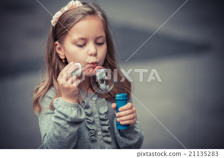 funny lovely little girl blowing soap bubble funny lovely little girl blowing soap bubble 21135283