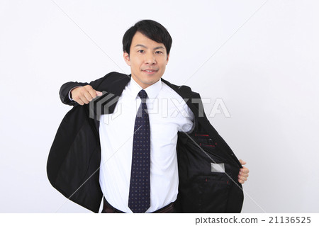 Businessman who takes off his coat Businessman who takes off his coat 21136525