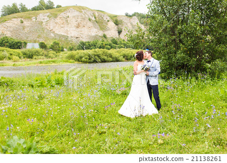 Bride and groom at wedding Day walking Outdoors on Bride and groom at wedding Day walking Outdoors on 21138261