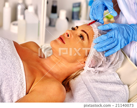Woman middle-aged in spa salon with beautician. Woman middle-aged in spa salon with beautician. 21140073