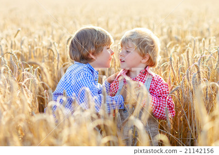 Two little sibling boys having fun and speaking on 21142156