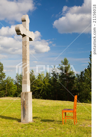 The stone cross and empty wooden chair The stone cross and empty wooden chair 21156018