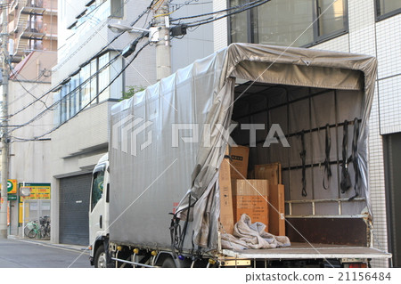Delivery trucks parked in the middle of the city to unload their cargo. Delivery trucks parked in the middle of the city to unload their cargo. 21156484