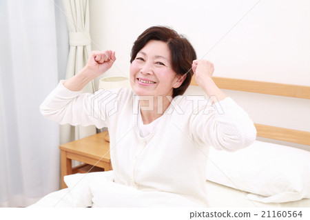 Woman getting up from bed 21160564