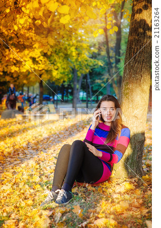 beautiful woman in autumn park 21163264