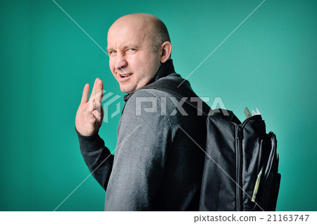 fastidious man with a backpack in studio fastidious man with a backpack in studio 21163747