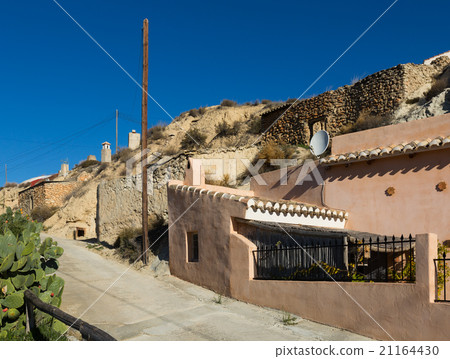 Street at village with dwelling houses into rocks Street at village with dwelling houses into rocks 21164430
