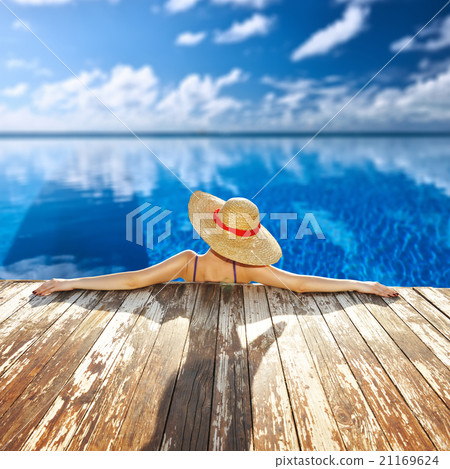 Woman at poolside Woman at poolside 21169624