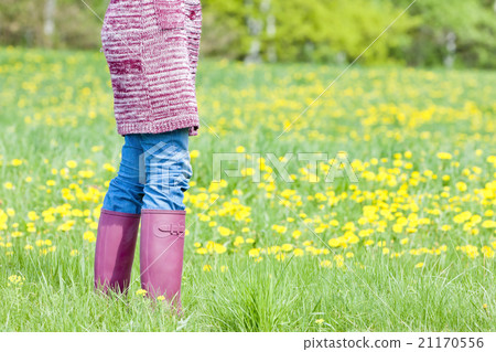 woman wearing rubber boots on spring meadow 21170556