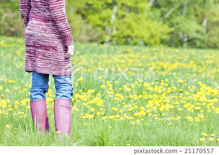 woman wearing rubber boots on spring meadow 21170557