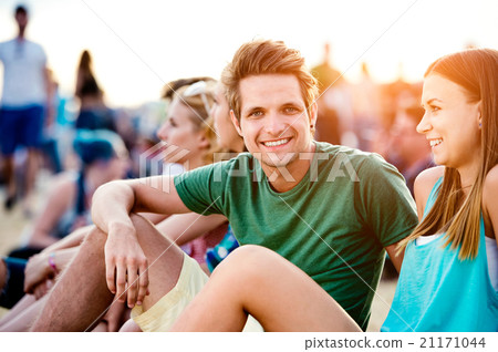 Teenagers at summer music festival, sitting on the Teenagers at summer music festival, sitting on the 21171044