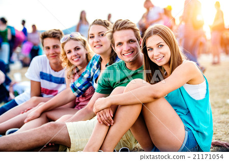 Teenagers at summer music festival, sitting on the Teenagers at summer music festival, sitting on the 21171054