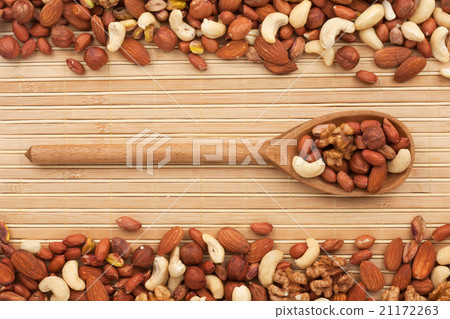Wooden spoon with  dried  nuts 21172263
