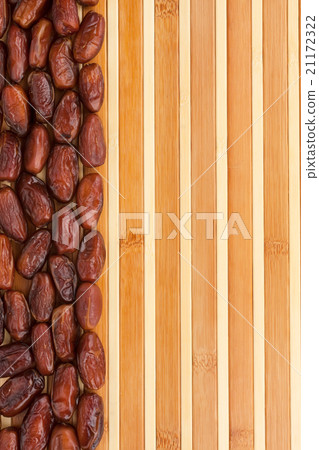 Dried dates lying on a bamboo mat Dried dates lying on a bamboo mat 21172322
