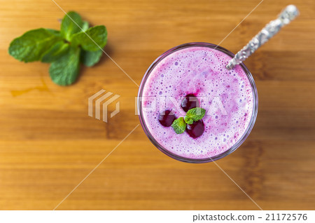 Glass of smoothie with cherry, mint leaves Glass of smoothie with cherry, mint leaves 21172576