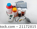Blood preasure tonometer and bottles on white 21172815