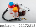 Medical phonendoscope, pills and colorful bottles 21172818