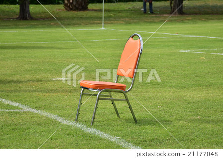 orange chair on green field 21177048