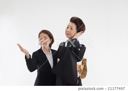 A woman in a formal kimono getting ready. Dresser, dressing, dressing, gestures 21177497
