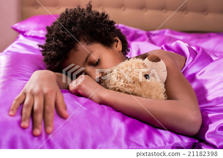 Afro boy sleeping with teddybear. Afro boy sleeping with teddybear. 21182398
