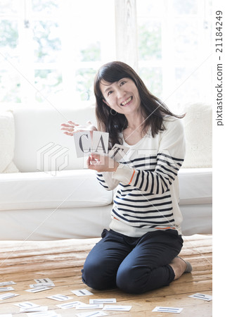 A woman with an alphabet card A woman with an alphabet card 21184249