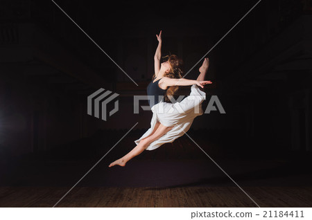 Young brunette dancer girl in split jump 21184411