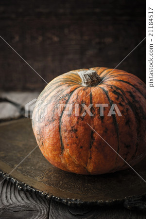 Orange pumpkin with green stripes on the tray Orange pumpkin with green stripes on the tray 21184517