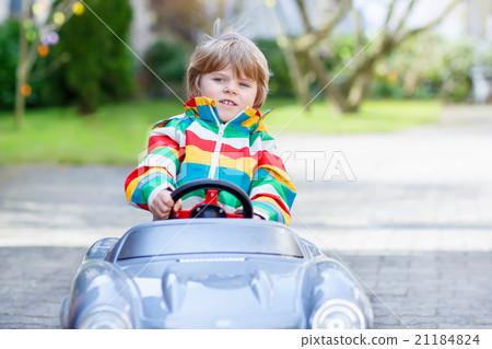 Little preschool boy driving big toy old vintage Little preschool boy driving big toy old vintage 21184824