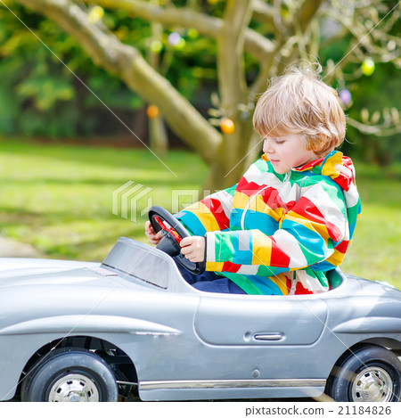 Little preschool boy driving big toy old vintage Little preschool boy driving big toy old vintage 21184826
