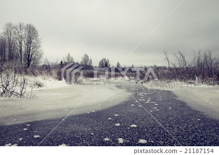 frozen creek in winter forest landscape frozen creek in winter forest landscape 21187154