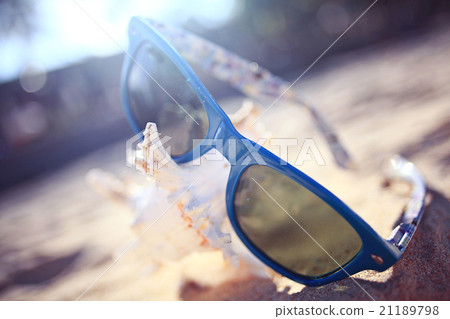 sunglasses on a sandy beach concept Summer sunglasses on a sandy beach concept Summer 21189798