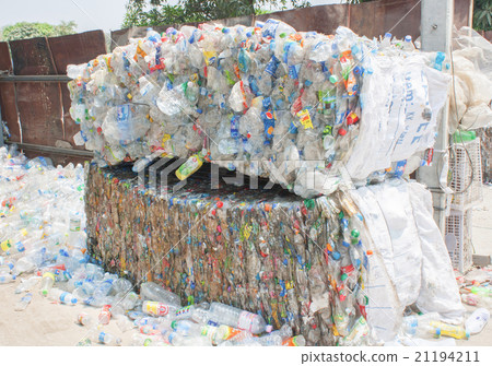 Plastic bottles pressed and packed for recycling 21194211