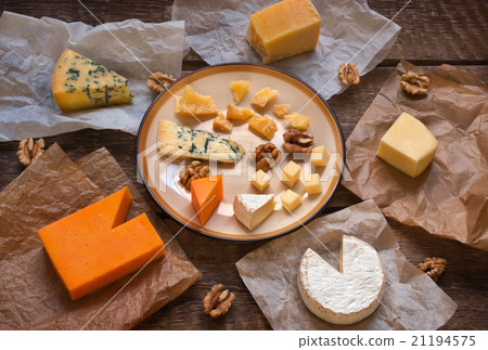 Assorted cheeses on the wooden table 21194575
