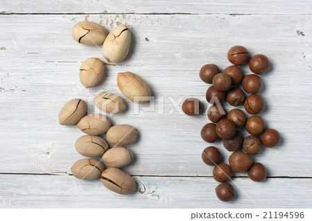 Pecan and macadamia nuts handfuls Pecan and macadamia nuts handfuls 21194596