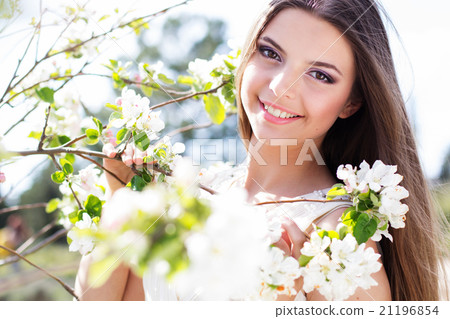 Beautiful girl in a apple blossom garden Beautiful girl in a apple blossom garden 21196854