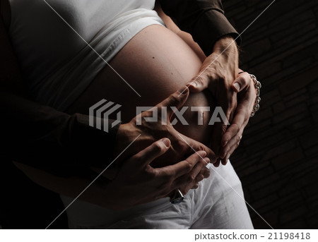 Pregnant woman belly exposed 21198418