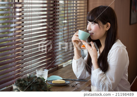 A woman at a cafe A woman at a cafe 21198489