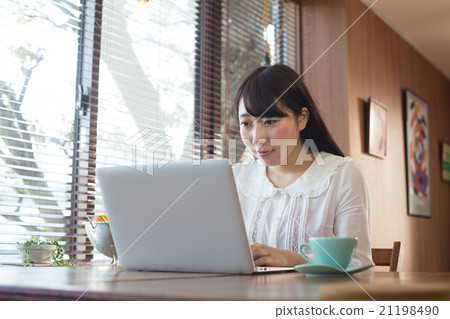 A woman at a cafe A woman at a cafe 21198490