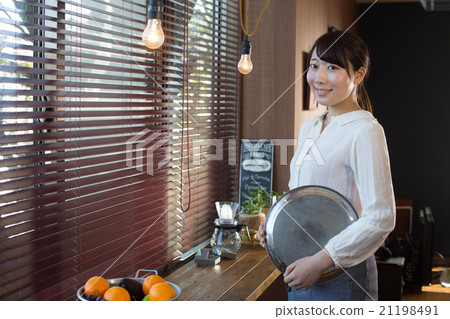 A woman working in a cafe A woman working in a cafe 21198491